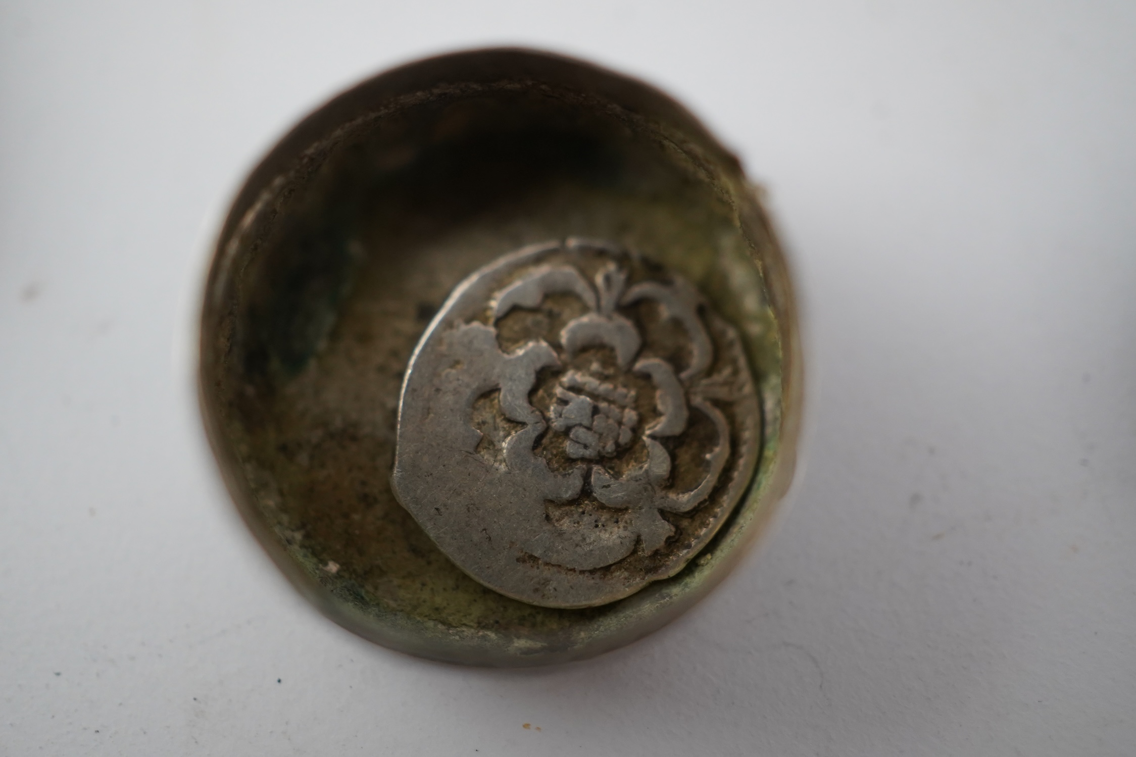 A 17th century style miniature silver snuff box, 40mm, a miniature 'book' box and a token/counter box with one counter. Condition - poor to fair